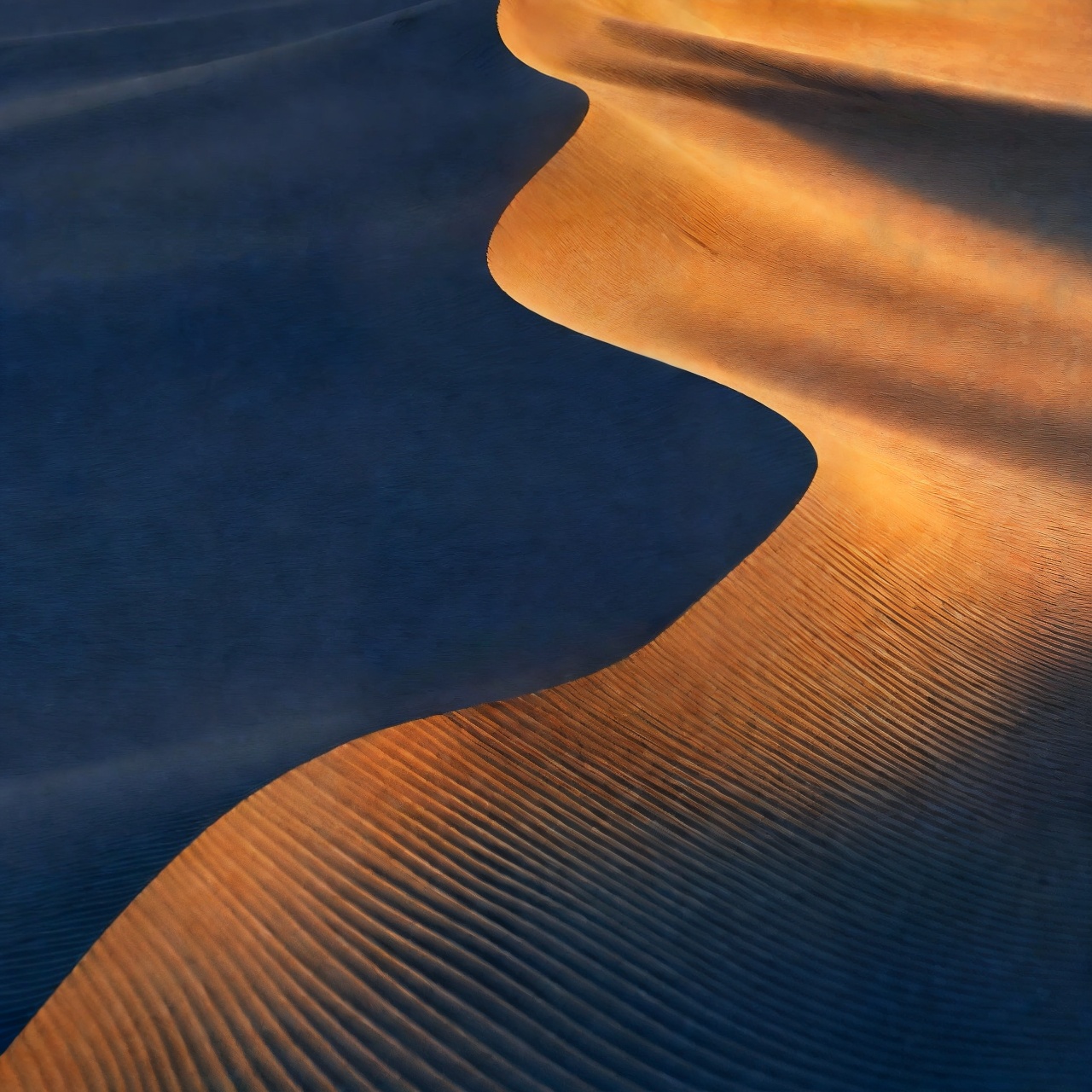AI-generated: Copper desert dunes with fine ripples and indigo shadows